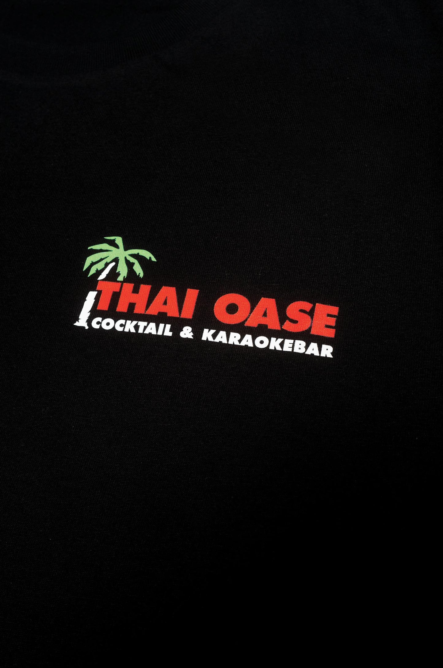 Detail vom Thai Oase Logo auf dem Basic Shirt in Schwarz